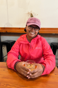 Solo black female traveler in Ghost Note Coffee in Seattle, Washington. Trying an iced coffee as part of the Seattle Coffee Culture Walking Tour