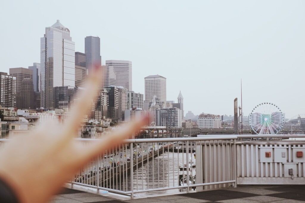Skyline of Seattle, Washington with a person sticking up their two fingers